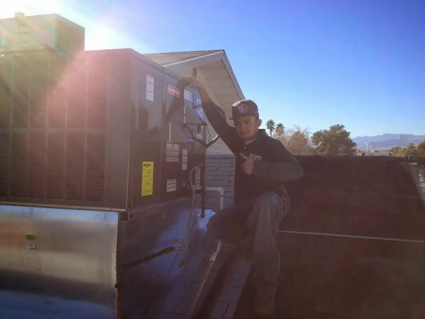 HVAC technician performing HVAC Inspection on a rooftop unit in Spring Hill